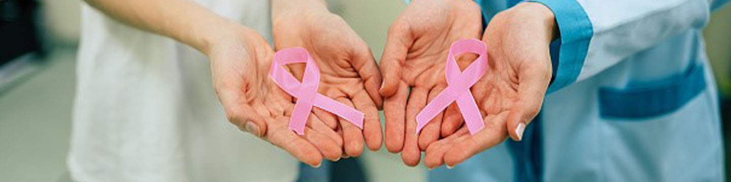 Two women showing cancer awareness medical stick ribbon for the healthcare of female breast and prevention of cancer